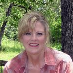 Sharon sitting on a stone bench on her Wise County farm.