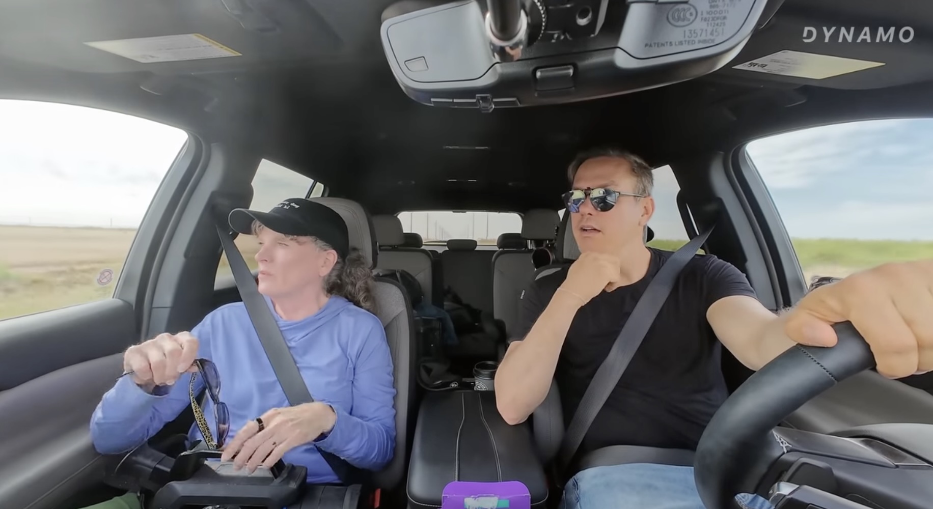 Sharon Wilson and the host of Business Explains the World in a car driving through Texas oil fields. 